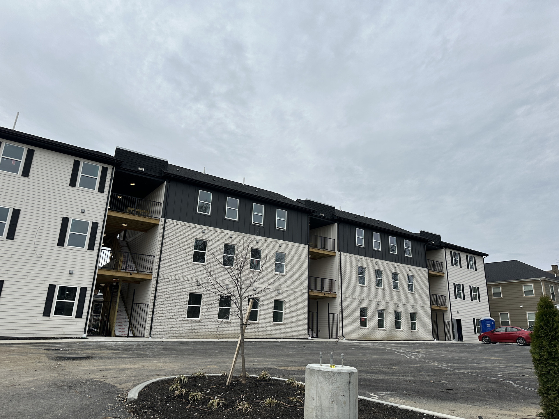 Front facade of Dora Lofts with brick and metal accents